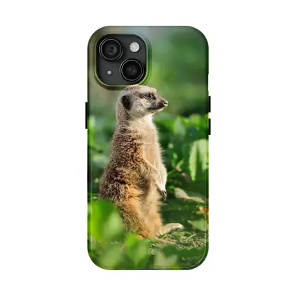Meerkat Standing Alert In Green Foliage
