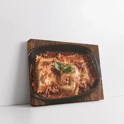 Ravioli Bolognese With Fresh Basil Garnish