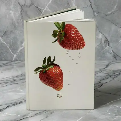 Two Fresh Strawberries Falling With Water Drops