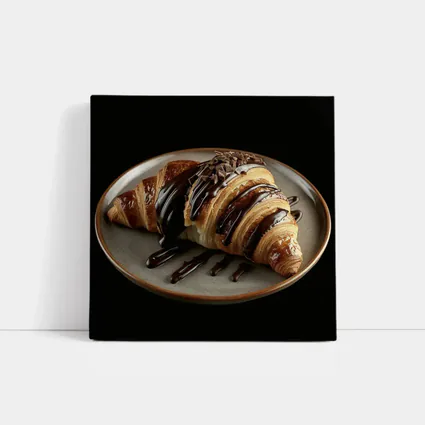 Chocolate Drizzled Croissant On Dark Plate