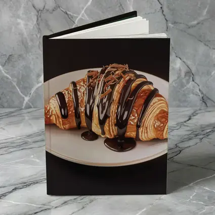 Chocolate Drizzled Croissant On White Plate
