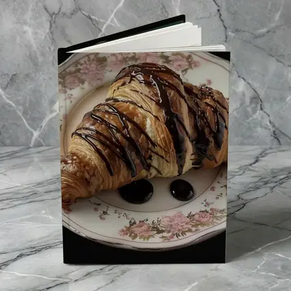 Chocolate Drizzled Croissant On Floral Plate