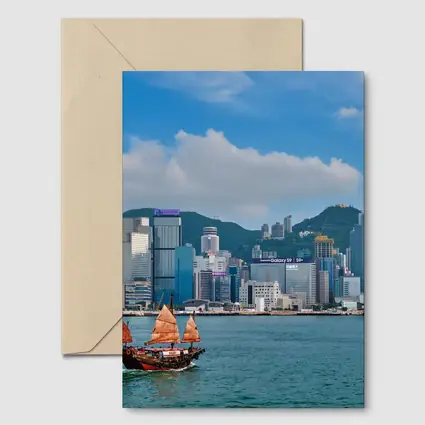 Hong Kong Harbor Skyline with Traditional Junk Boat