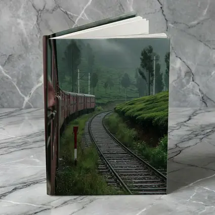 Red Train Winding Through Misty Tea Plantations