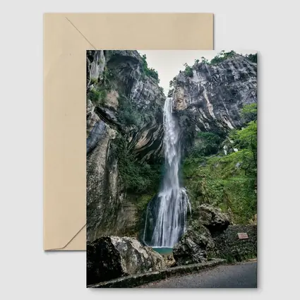 Tall Waterfall Cascading Down Rocky Cliffs