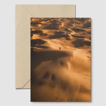 Lone Figure Walking Vast Golden Desert Dunes