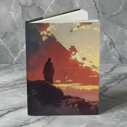 Lone Figure Standing on Rocky Sunset Cliff