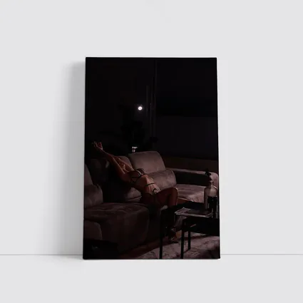 Woman in Lingerie Relaxing on Dark Sofa