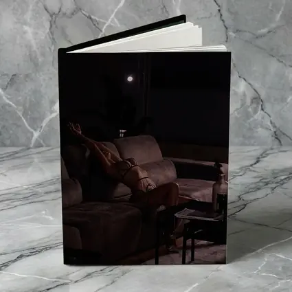 Woman in Lingerie Relaxing on Dark Sofa
