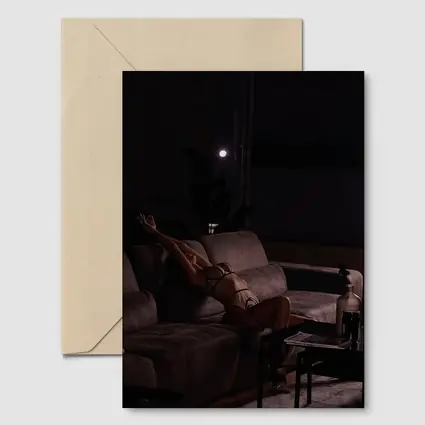 Woman in Lingerie Relaxing on Dark Sofa