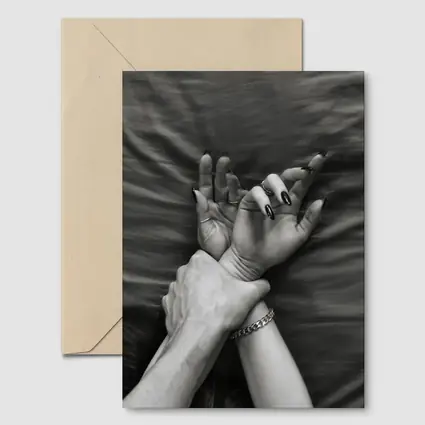 Black and White Hands Grasping Bed Sheet