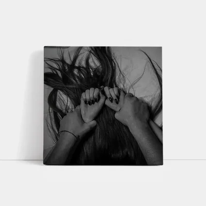 Black and White Hands Grasping Dark Hair