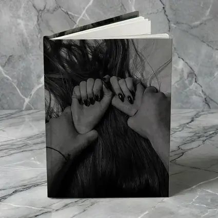 Black and White Hands Grasping Dark Hair