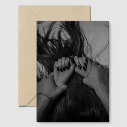 Black and White Hands Grasping Dark Hair