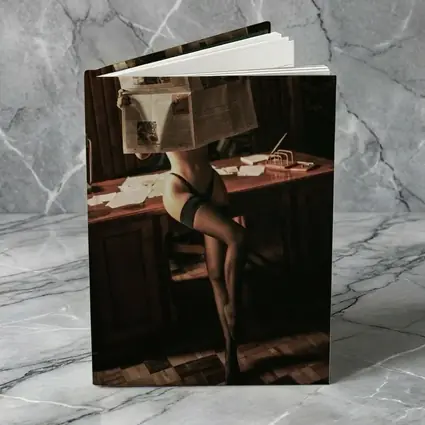Sexy Woman Reading Newspaper at Office Desk