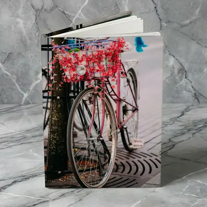 Pink Bicycle With Flowers On City Street