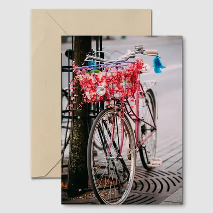 Pink Bicycle With Flowers On City Street
