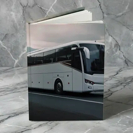 White Coach Bus Driving Through Mountain Road