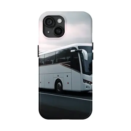 White Coach Bus Driving Through Mountain Road