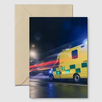 Ambulance Racing Through City Night Streets