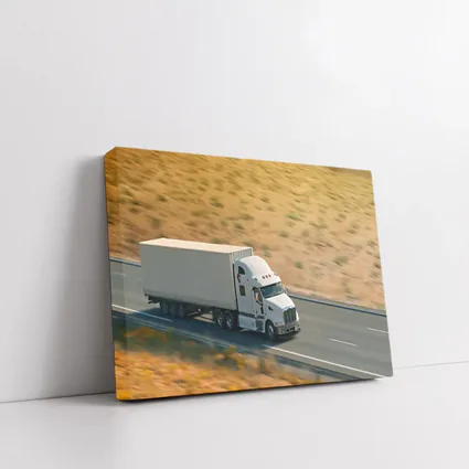 White Semi Truck Speeding Down Desert Highway