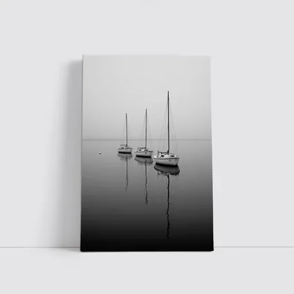 Three Sailboats Reflecting on Foggy Water