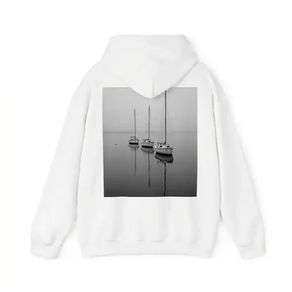 Three Sailboats Reflecting on Foggy Water