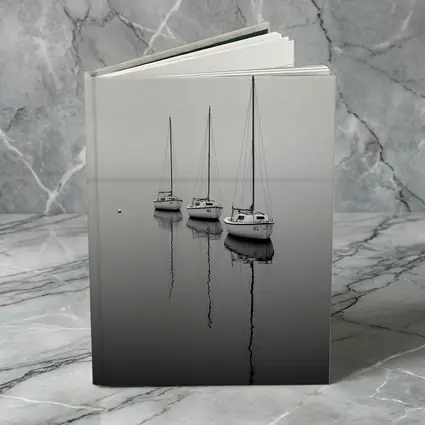 Three Sailboats Reflecting on Foggy Water