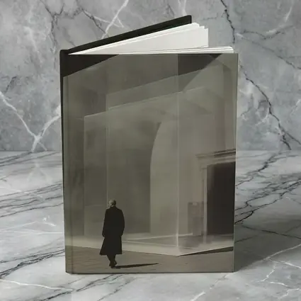 Man Walking Past Translucent Glass Architecture