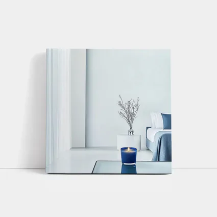Blue Candle Glowing in Minimalist White Room
