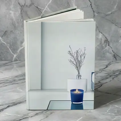 Blue Candle Glowing in Minimalist White Room