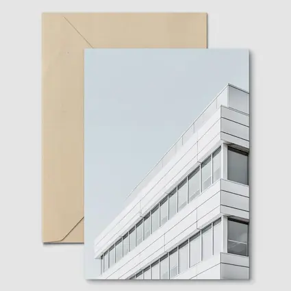 White Modern Building Corner Against Gray Sky