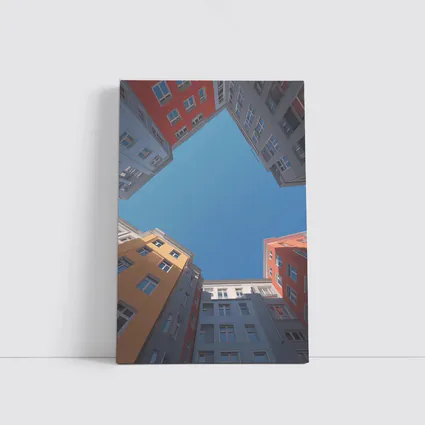 Looking Up Between Colorful City Buildings Sky