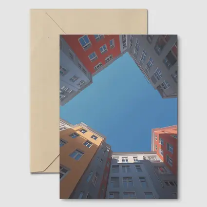Looking Up Between Colorful City Buildings Sky