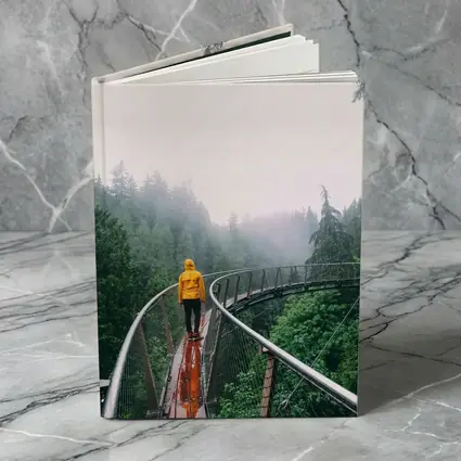 Yellow Jacket Hiker on Misty Forest Bridge