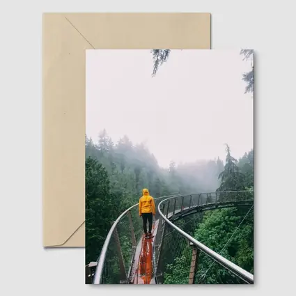 Yellow Jacket Hiker on Misty Forest Bridge