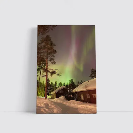 Northern Lights Over Snowy Winter Cabins