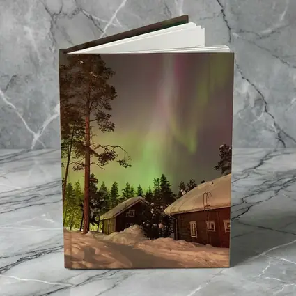 Northern Lights Over Snowy Winter Cabins