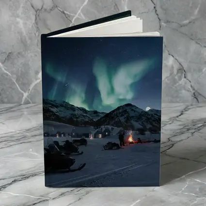 Northern Lights Over Snowy Mountain Village