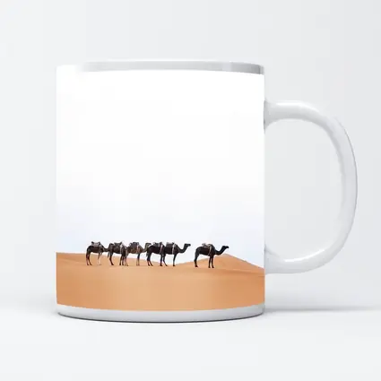 Camel Caravan Walking Across Desert Dunes