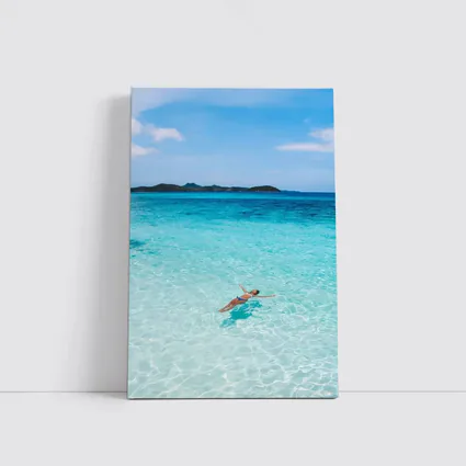 Woman Floating In Turquoise Tropical Ocean