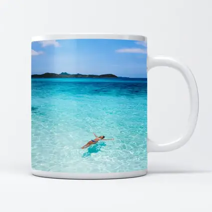 Woman Floating In Turquoise Tropical Ocean