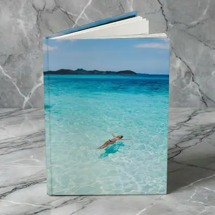 Woman Floating In Turquoise Tropical Ocean