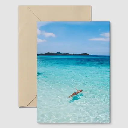 Woman Floating In Turquoise Tropical Ocean