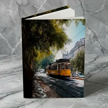 Yellow Tram on Lisbon Cobblestone Tree Street