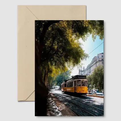 Yellow Tram on Lisbon Cobblestone Tree Street
