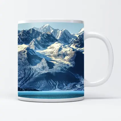 Snow Capped Mountains Over Turquoise Glacial Lake