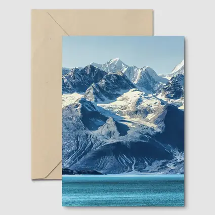Snow Capped Mountains Over Turquoise Glacial Lake