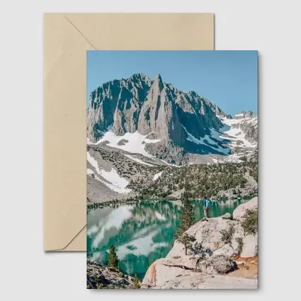 Hiker Standing by Alpine Lake Mountain