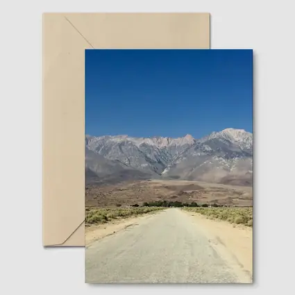 Desert Road Leading To Sierra Nevada Mountains